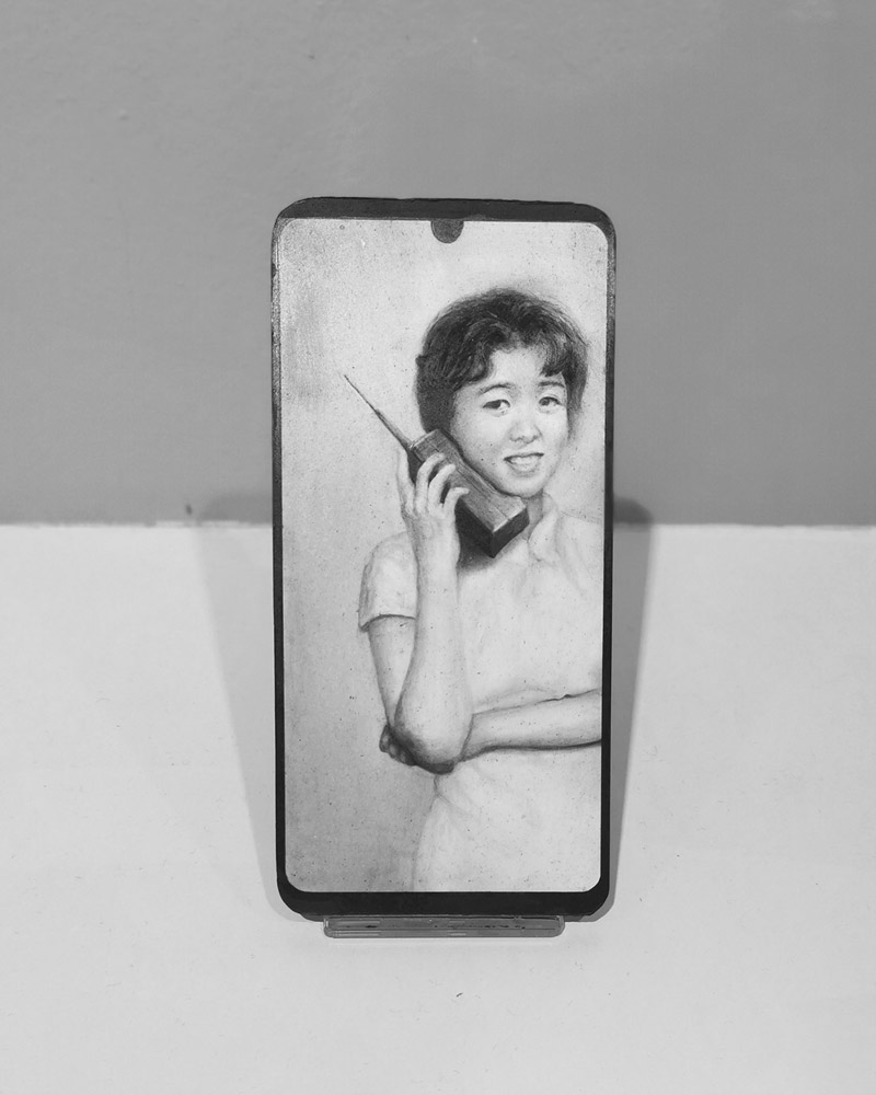 Elegant Chinese lady holding an old vintage mobile phone